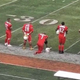 Camron McGarity kneels on the sideline as the national anthem is played during a charity football game in Chicago on June 2, 2018.